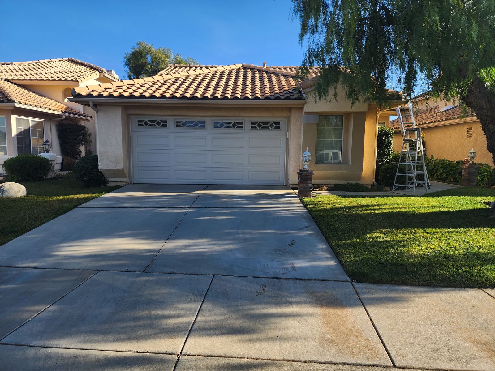 Before: faded stucco and chalking trim